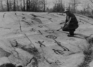 Peterborugh Petroglyphs with man examining